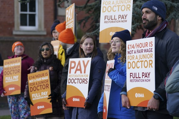 Striking NHS junior doctors stand on the picket line outside Leicester Royal Infirmary as the BMA holds a 96-hour walkout in a dispute over pay, in Leicester, England, Tuesday April 11, 2023. (Jacob K ...