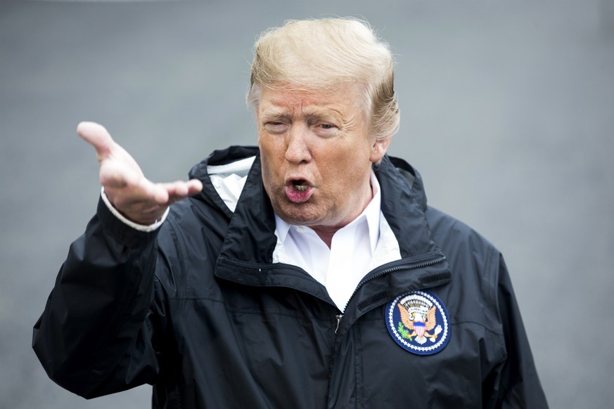 epa07422477 US President Donald J. Trump delivers remarks to members of the news media outside the South Portico before departing the South Lawn of the White House by Marine One, in Washington, DC, US ...