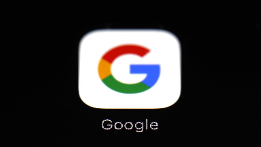 FILE - This March 19, 2018 file photo shows a Google app in Baltimore. Google says Apple has also revoked its access to a key developer tool, preventing its employees from testing new app features on  ...