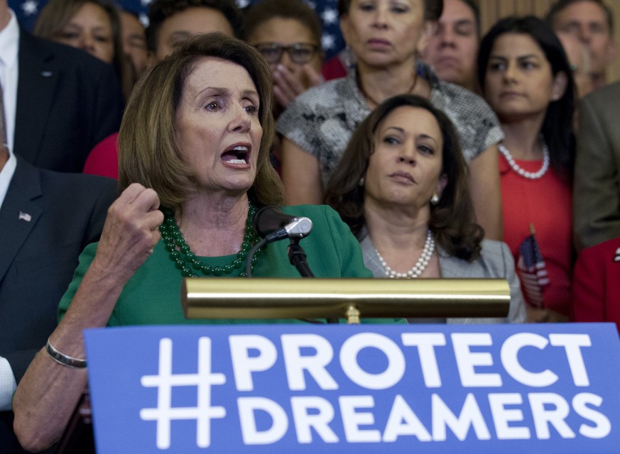 House Minority Leader Nancy Pelosi of Calif. accompanied by members of the House and Senate Democrats, gestures during a news conference on Capitol Hill in Washington, Wednesday, Sept. 6, 2017. House  ...