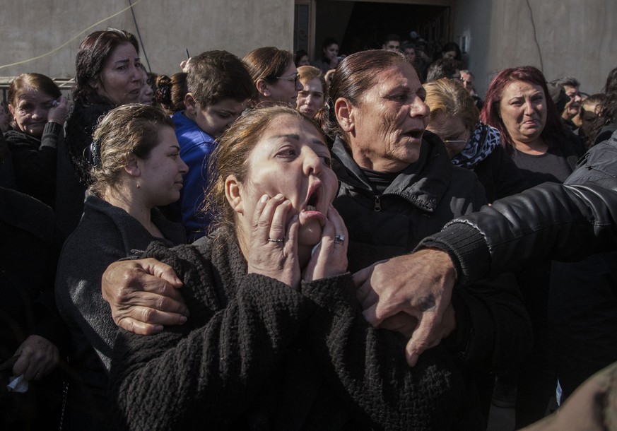 FILE - In this Nov. 22, 2019 file photo, people attend the funeral of Said Abdel Ahad, a Christian fighter of the Syriac Military Council, in Hassakeh, Syria. Ahad was killed in a Turkish offensive ne ...