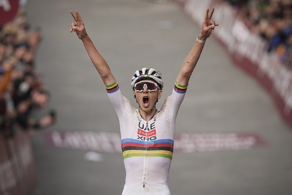 Tadej Pogacar, of Slovenia, celebrates winning 19th edition of the Strade Bianche (White Roads), a 213 km (132-mile) one-day race route through Tuscany, Saturday March 8, 2025, in Siena, Italy,. (Marc ...