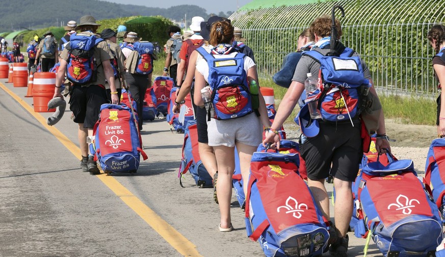 British scout members leave the World Scout Jamboree campsite in Buan, South Korea, Sunday, Aug. 6, 2023. South Korea is preparing to evacuate tens of thousands of scouts from a coastal jamboree site  ...