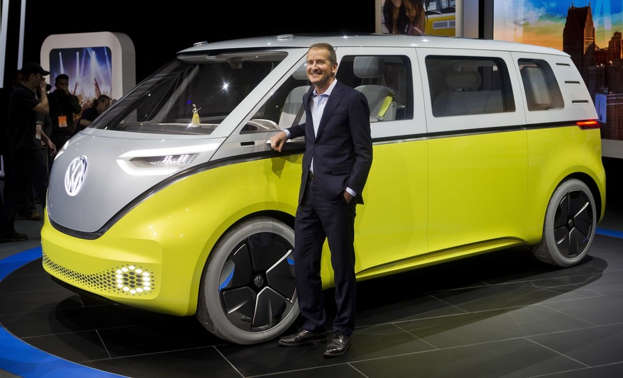 FILE - In a Jan. 9, 2017, file photo, Herbert Diess, chairman of the Volkswagen brand, poses with the I.D. Buzz all-electric concept van, at the North American International Auto Show, in Detroit. The ...
