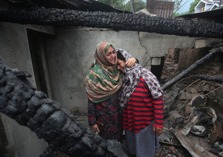 epa12102635 (FILE) - Kashmiri women grieve inside their house damaged after cross-border shelling from Pakistan, at Salamabad village in Uri, north of Srinagar, the summer capital of Indian Kashmir, 0 ...