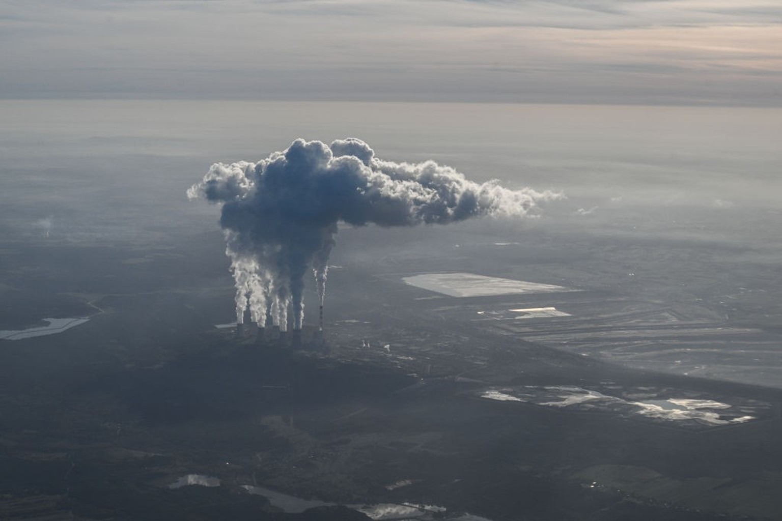 BELCHATOW, POLAND - OCTOBER 12: Steam and smoke rises from the Belchatow Coal Powered Station, as seen from an aircraft on October 12, 2022 in Belchatow, Poland. The Belchatow coal-powered station, wi ...