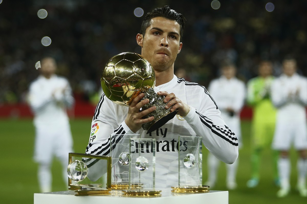 Real Madrid's Cristiano Ronaldo from Portugal holds the Balon D'Or trophy before a King's Cup soccer match between Atletico de Madrid and Real Madrid at the Santiago Bernabeu stadium in ...