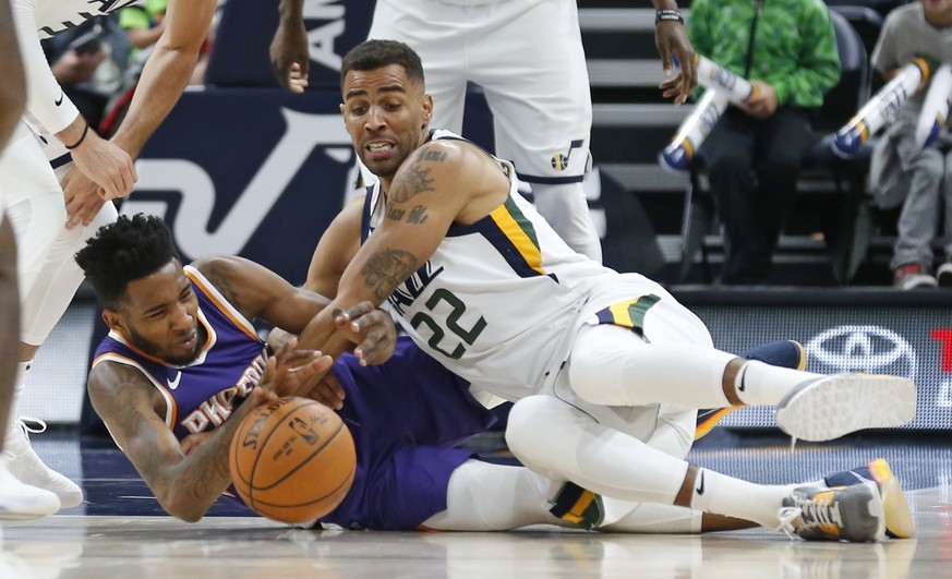 Phoenix Suns forward Derrick Jones Jr., left, and Utah Jazz forward Thabo Sefolosha (22) vie for a loose ball during the second half of a preseason NBA basketball game Friday, Oct. 6, 2017, in Salt La ...