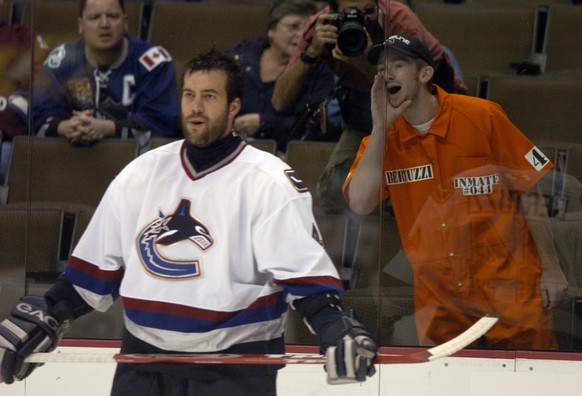 Derek Staudt, 19, of Arvada, Colo., right, yells at the Vancouver Canucks&#039; Todd Bertuzzi during the Canucks skate-around prior to the game against the Colorado Avalanche, at the Pepsi Center Thur ...