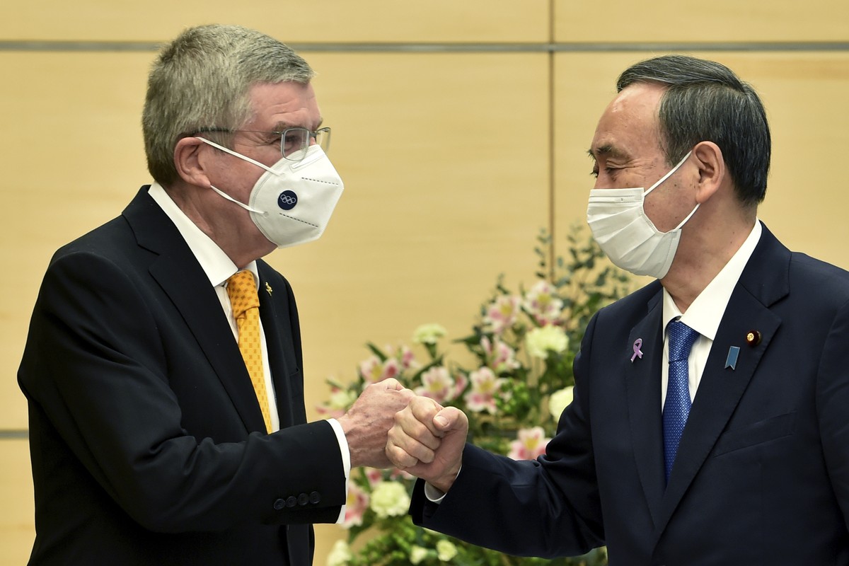 Japan's Prime Minister Yoshihide Suga, right, greets International Olympic Committee (IOC) President Thomas Bach during their meeting in Tokyo, Monday, Nov. 16, 2020. IOC President Bach is beginn ...