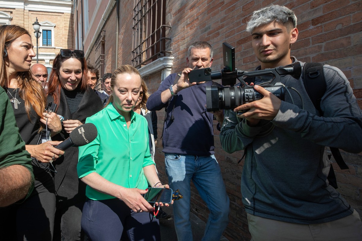 epa10643803 Italian Prime Minister Giorgia Meloni (C) arrives in the Prefecture of Ravenna for a meeting with residents after floodwaters hit the Emilia-Romagna region, in Ravenna, Italy, 21 May 2023. ...