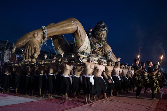 CORRECTS TO CLARIFY PARADE TAKES PLACE THE EVENING BEFORE NYEPI- Participants carry a giant ogoh-ogoh effigy representing evil spirits to be cleansed during a parade on the evening before Nyepi, the D ...
