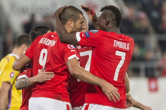 Swiss Breel Embolo, right, celebrates Eren Derdiyok, who scored to 7:0 during the UEFA EURO 2016 qualifying group E soccer match Switzerland against San Marino, at the AFG Stadium in St. Gallen, Switz ...