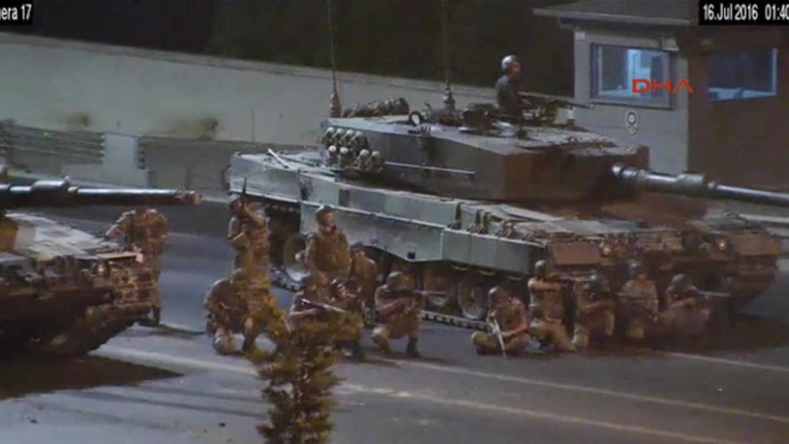 In this image taken from video, military fire on a crowd of protesters from their road block on the Bosphorus Bridge, Istanbul, Saturday July 16, 2016. In the CCTV video obtained by Turkish Dogan news ...