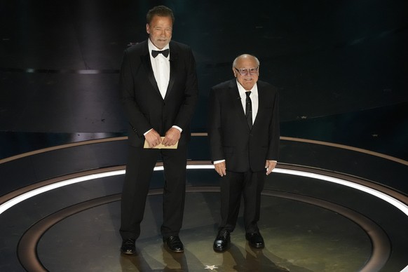 Arnold Schwarzenegger, left, and Danny DeVito presents the award for best visual effects during the Oscars on Sunday, March 10, 2024, at the Dolby Theatre in Los Angeles. (AP Photo/Chris Pizzello)
Arn ...