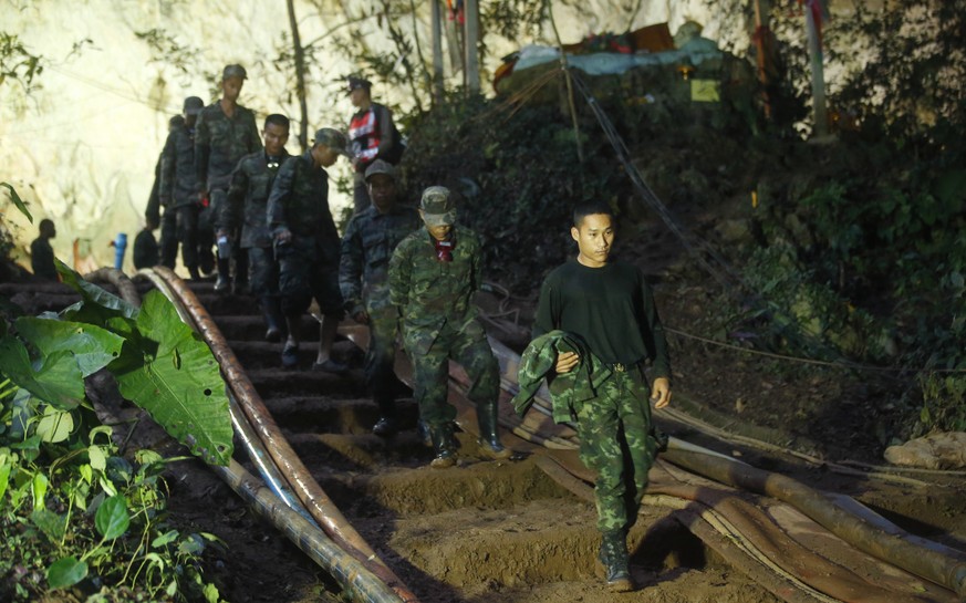 Rescuers make their way down at the entrance to a cave complex where 12 boys and their soccer coach went missing, in Mae Sai, Chiang Rai province, in northern Thailand, Monday, July 2, 2018. Rescue di ...