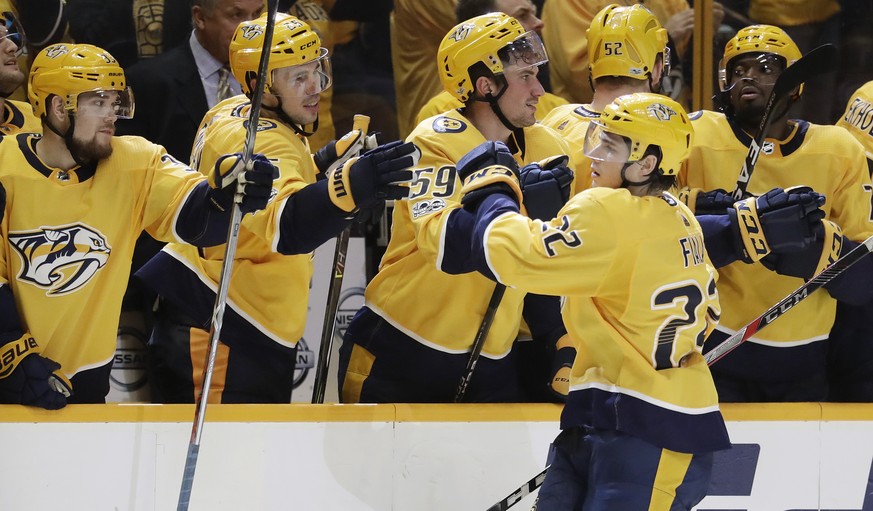 Nashville Predators left wing Kevin Fiala (22), of Switzerland, celebrates with teammates after scoring a goal against the Anaheim Ducks during a shootout in an NHL hockey game Saturday, Dec. 2, 2017, ...