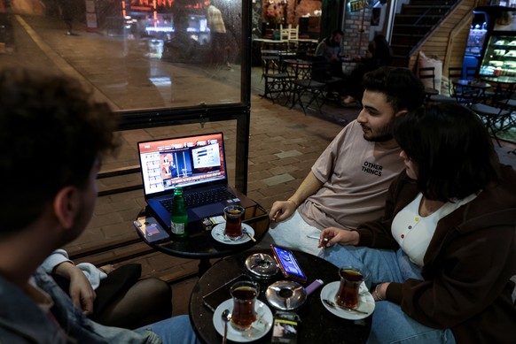 epa10628554 People watch the news awaiting the official election results at a cafe in Istanbul, Turkey, 14 May 2023, as the country holds simultaneous parliamentary and presidential elections. EPA/ERD ...