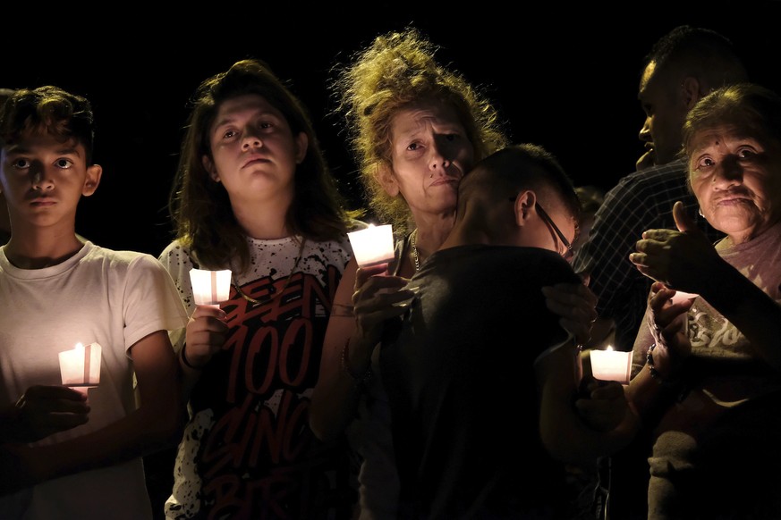 From left are Christopher Rodriguez, Esmeralda Rodriguez, Mona Rodriguez, Jayanthony Hernandez, 12 and Juanita Rodriguez, participate in a candlelight vigil held for the victims of a fatal shooting at ...