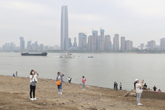 Residents visit the Yangtze River in Wuhan in central China&#039;s Hubei province Monday, March 29, 2021. A joint WHO-China study on the origins of COVID-19 says that transmission of the virus from ba ...