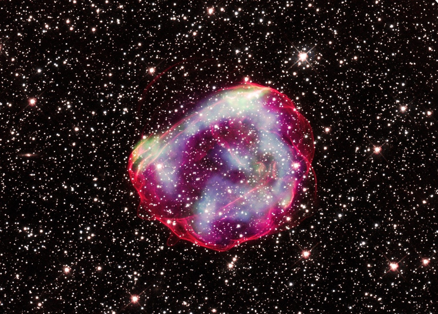 These delicate wisps of gas make up an object known as SNR B0519-69.0, or SNR 0519 for short. The thin, blood-red shells are actually the remnants from when an unstable progenitor star exploded violen ...