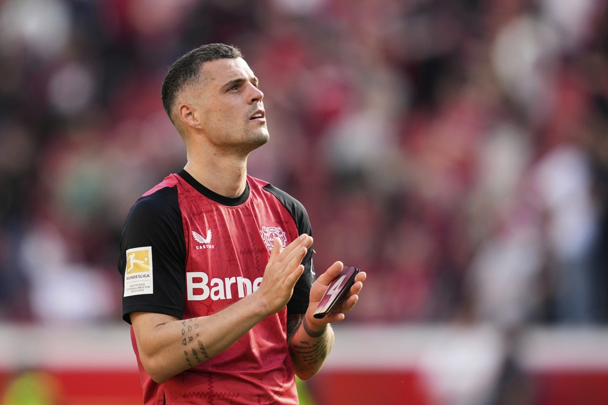 Leverkusen's Granit Xhaka applauds supporters at the end of the German Bundesliga soccer match between Bayer Leverkusen and FC Augsburg at the BayArena in Leverkusen, Germany, Saturday, April 26, ...