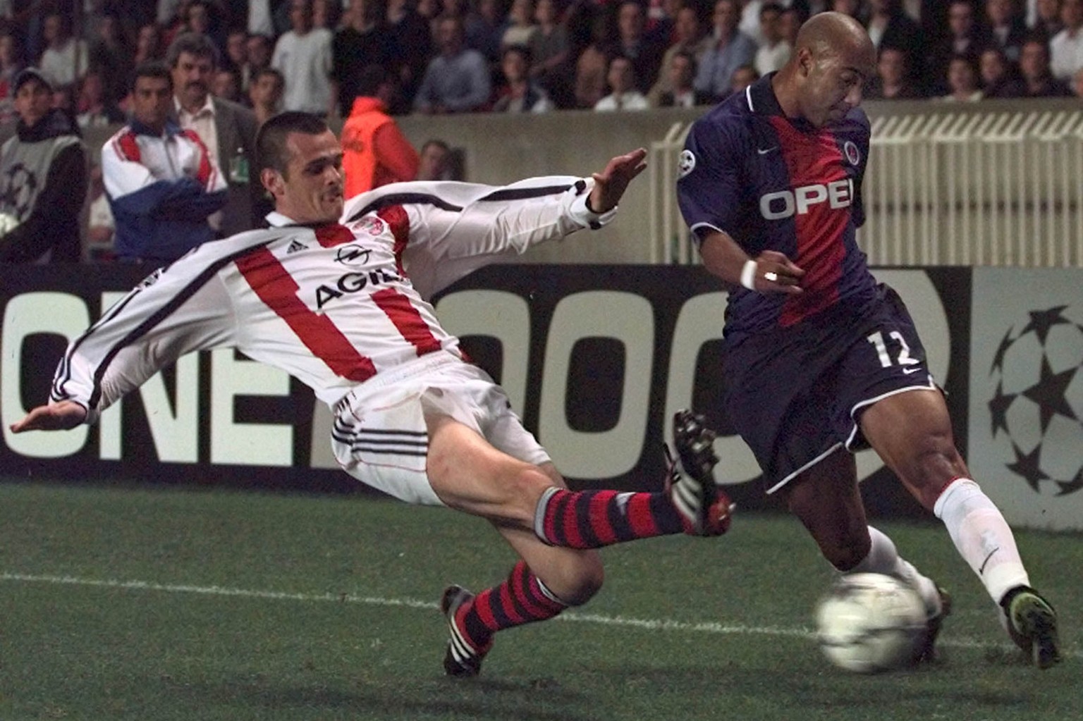 Paris SG player Stephane Dalmat, right, is tackled by an unidentified Bayern player during their Champions League, Group F, soccer match between Paris Saint Germain and Bayern Munich at the Parc des P ...