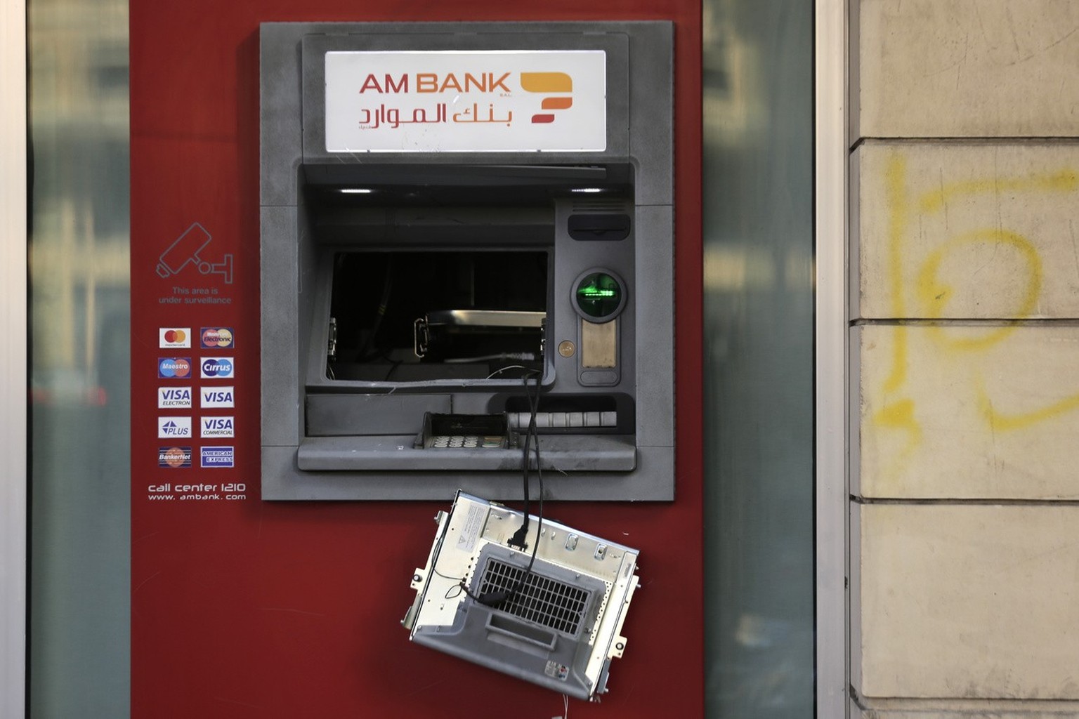 An ATM machine damaged by protesters after a protest against the Lebanese government in Beirut, Lebanon, Saturday, Oct. 19, 2019. The blaze of protests was unleashed a day earlier when the government  ...