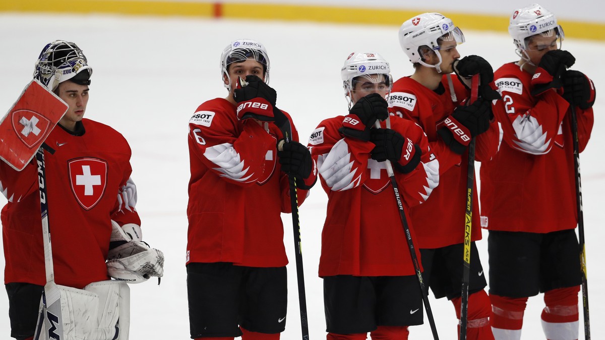 Switzerland's players stand on ice after the U20 Ice Hockey Worlds quarterfinal match between Switzerland and Russia in Trinec, Czech Republic, Thursday, Jan. 2, 2020. (AP Photo/Petr David Josek)