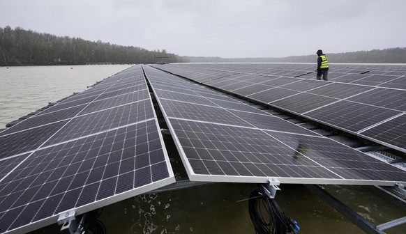 FILE - Solar panels are installed at a floating photovoltaic plant on a lake in Haltern, on Friday, April 1, 2022. Long periods of sunshine took solar power generation in Europe to a record high this  ...