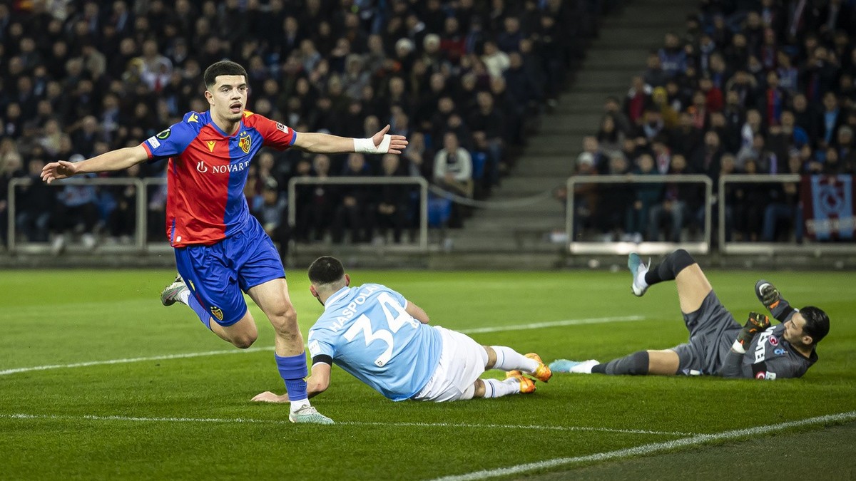 Basel's Zeki Amdouni, left, reacts after scoring the first goal for his team during the UEFA Europa Conference League play-off second leg soccer match between Switzerland's FC Basel 1893 and ...