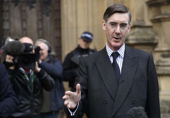 Pro-Brexit, Conservative lawmaker Jacob Rees-Mogg gestures as he speaks to the media outside the Houses of Parliament in London, Thursday, Nov. 15, 2018. A pro-Brexit group of Conservative lawmakers s ...