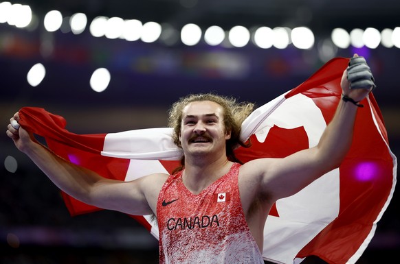 epa11526312 Ethan Katzberg of Canada celebrates after winning the Men Hammer Throw final of the Athletics competitions in the Paris 2024 Olympic Games, at the Stade de France stadium in Saint Denis, F ...