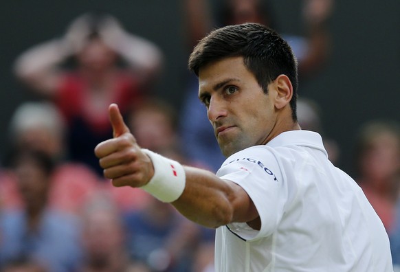 Novak Djokovic of Serbia gives a thumbs up to Marin Cilic of Croatia during their match at the Wimbledon Tennis Championships in London, July 8, 2015. REUTERS/Suzanne Plunkett