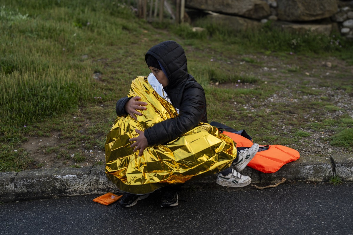 A woman and a child, both Kurdish migrants, rest after a failed attempt to reach the United Kingdom by boat, as they were discovered by the police in Ambleteuse, in northern France, on Sunday, May 19, ...