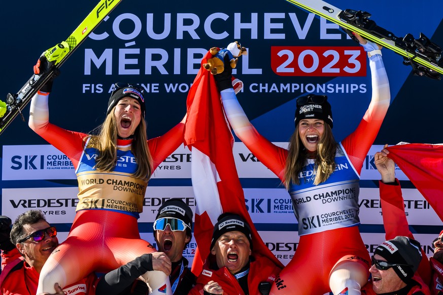 epaselect epa10460615 Gold medalist Jasmine Flury (L) of Switzerland, and bronze medalist Corinne Suter of Switzerland celebrate with their team on the podium for the Women&#039;s Downhill race at the ...