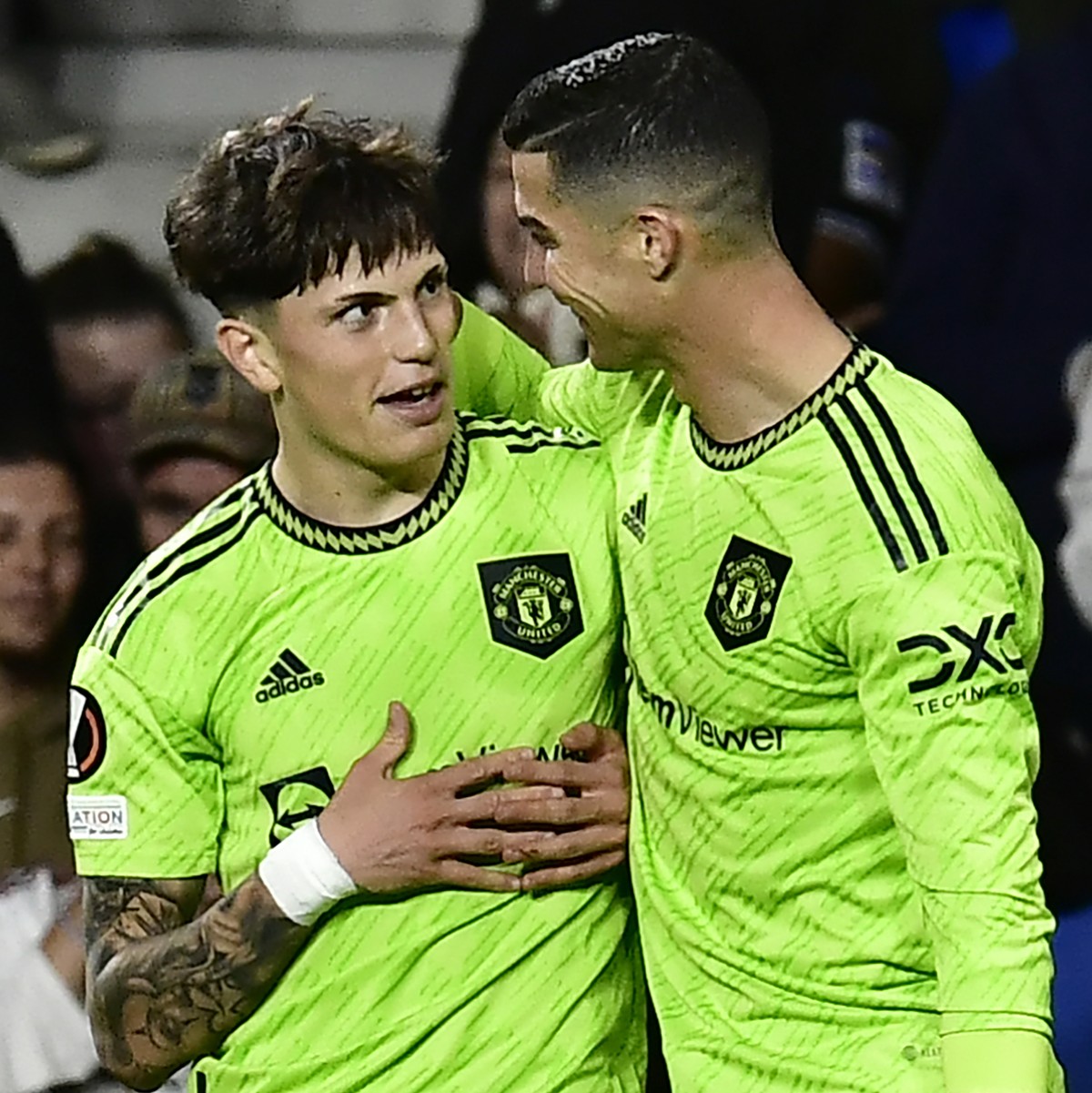 Manchester United's Alejandro Garnacho, left, celebrates with teammate Cristiano Ronaldo after scoring his side's first goal during the Europa League Group E soccer match between Real Socied ...