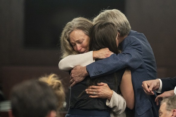 Parents of Anna Moriah Wilson, Karen Wilson and Eric Wilson, embrace Caitlin Cash, friend of Anna &quot;Mo&quot; Wilson, following the sentencing portion of Kaitlin Armstrong&#039;s murder trial at th ...