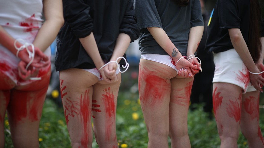 epa09933540 Women take part in a protest in front of the Consulate of the Russian Federation in Krakow, Poland, 08 May 2022. Women protest against rapes of women and children in Ukraine by Russian sol ...