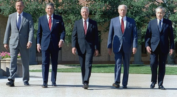 In a photo President George Bush, left, walks with former Presidents Ronald Reagan, Jimmy Carter, Gerald Ford, and Richard Nixon in the courtyard of the Ronald Reagan Presidential Library Monday, Nov. ...