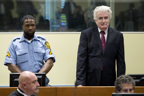 epa07450691 Former Bosnian Serb leader Radovan Karadzic (R) enters the court room of the Former Bosnian Serb leader Radovan Karadzic (R) enters the court room of the International Residual Mechanism f ...
