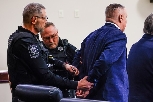 Colin Gray, the father of Apalachee High School shooting suspect Colt Gray, is handcuffed and escorted out of the room after jury deliberations at his trial at Barrow County Courthouse in Winder, Ga., ...