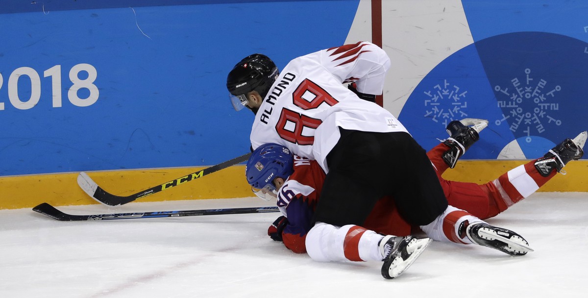 Cody Almond (89), of Switzerland, and Tomas Mertl (86), of the Czech Republic, battle for the puck during the first period of the preliminary round of the men's hockey game at the 2018 Winter Oly ...