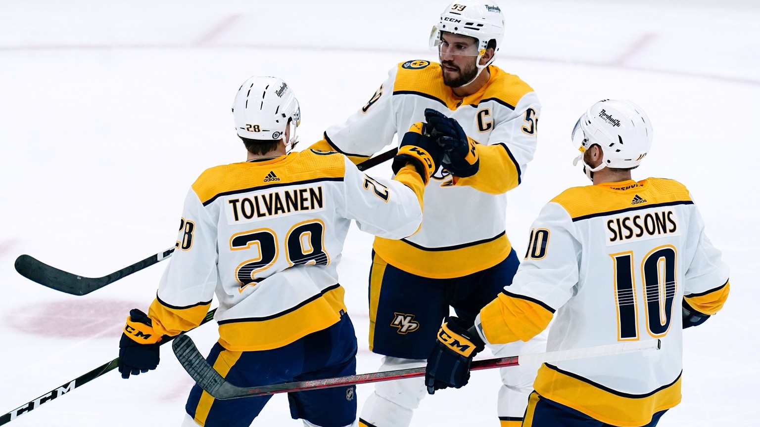 Nashville Predators right wing Eeli Tolvanen (28) celebrates his goal against the Arizona Coyotes with center Colton Sissons (10) and defenseman Roman Josi (59) during the first period of an NHL hocke ...