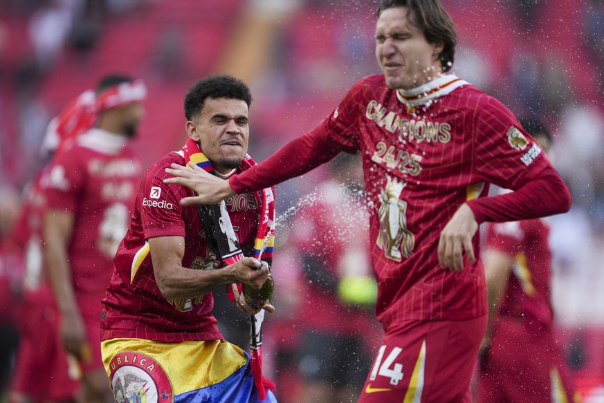 Liverpool's Luis Diaz, left, and Liverpool's Federico Chiesa celebrate after winning the English Premier League soccer match between Liverpool and Tottenham Hotspur and clinching the Premier ...
