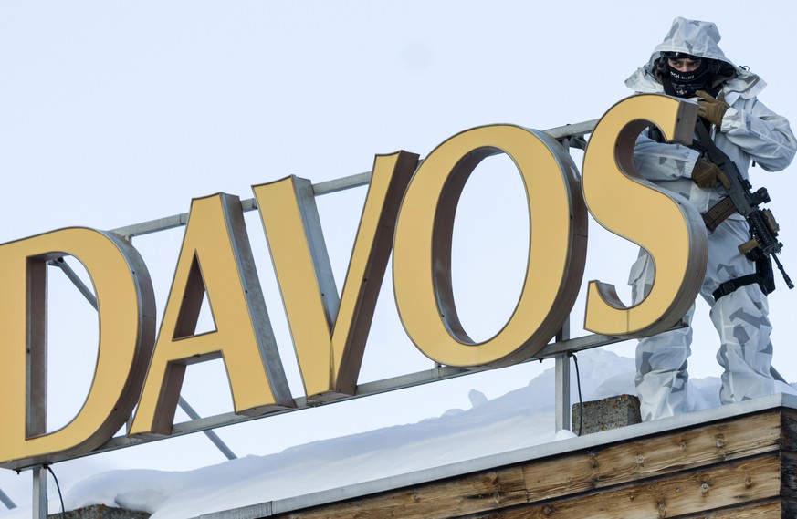 epa08627282 (FILE) - A policeman monitors the area next to the Congress Center from an adjacent roof during the 50th annual meeting of the World Economic Forum (WEF) in Davos, Switzerland, 20 January  ...