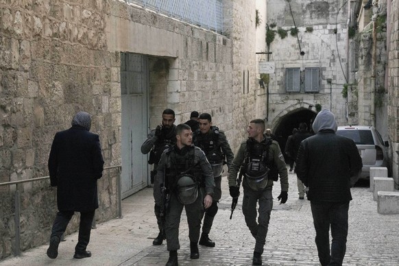 Israeli Border Police patrol in the Old City of Jerusalem as Palestinians walk to the Al Aqsa Mosque compound for prayers, Sunday, March 6, 2022. Israeli police say officers shot and killed a Palestin ...
