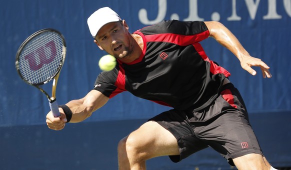 epa05514636 Marco Chiudinelli of Switzerland hits a return to Guillherme Clezar of Brazil during their match on the first day of the US Open Tennis Championship at the USTA National Tennis Center in F ...