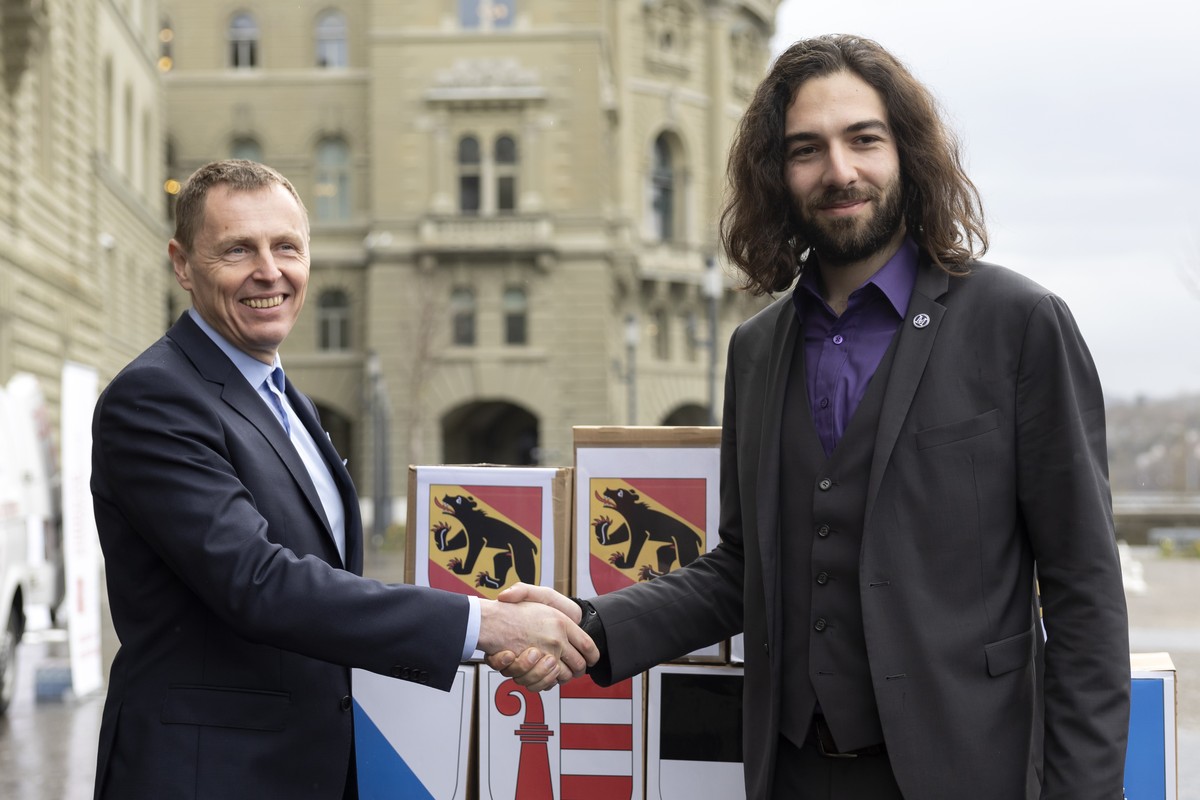 Nicolas Rimoldi, Praesident "Mass Voll", rechts, und Roland Buehlmann, Co-Praesident "Freunde der Verfassung", links, posieren vor den Schachteln mit den gesammelten Unterschriften ...