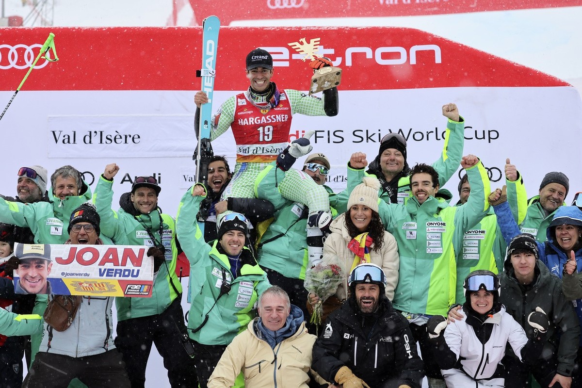 Andorra's Joan Verdu, center, celebrates with the team after taking third place in an alpine ski, men's World Cup giant slalom race, in Val d'Isere, France, Saturday, Dec.9, 2023. (AP P ...